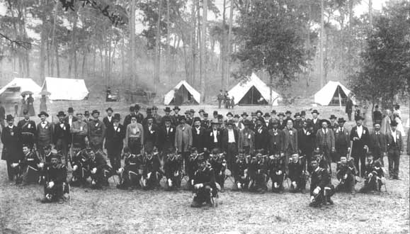 Veterans gathering, Lake County, Florida, 1895. The men shown standing in the photograph are members of both the G.A.R. and U.C.V. veterans organizations. The former enemies met to conduct a sham battle (reenactment) for entertainment. (Florida State Archives)