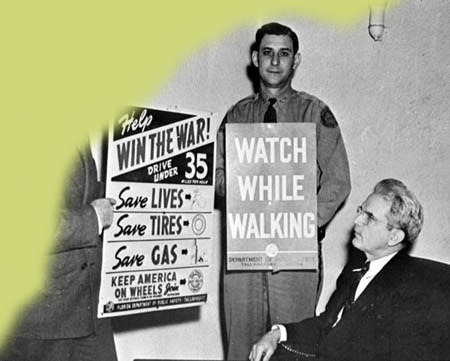 Governor Spessard L. Holland with defense posters, 1943 Governor Spessard L. Holland with defense posters, 1943