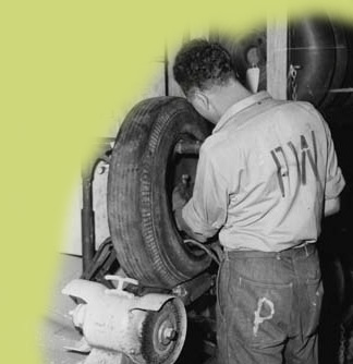 German prisoner of war (POW) repairing a tire at a Miami Beach military garage