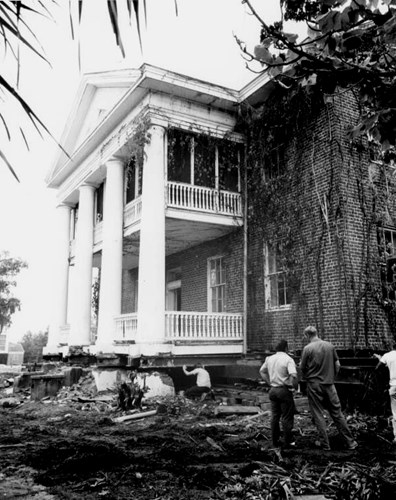 A young boy checks out the space under the lifted structure. Courtesy of the State Archives of Florida.